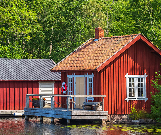 Smaller red boathouse on lake