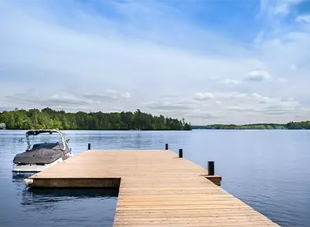 dock on a lake with a small boat