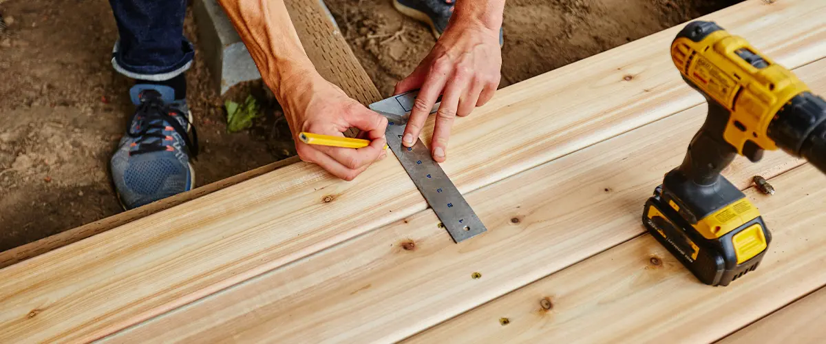 Man working on wooden deck.