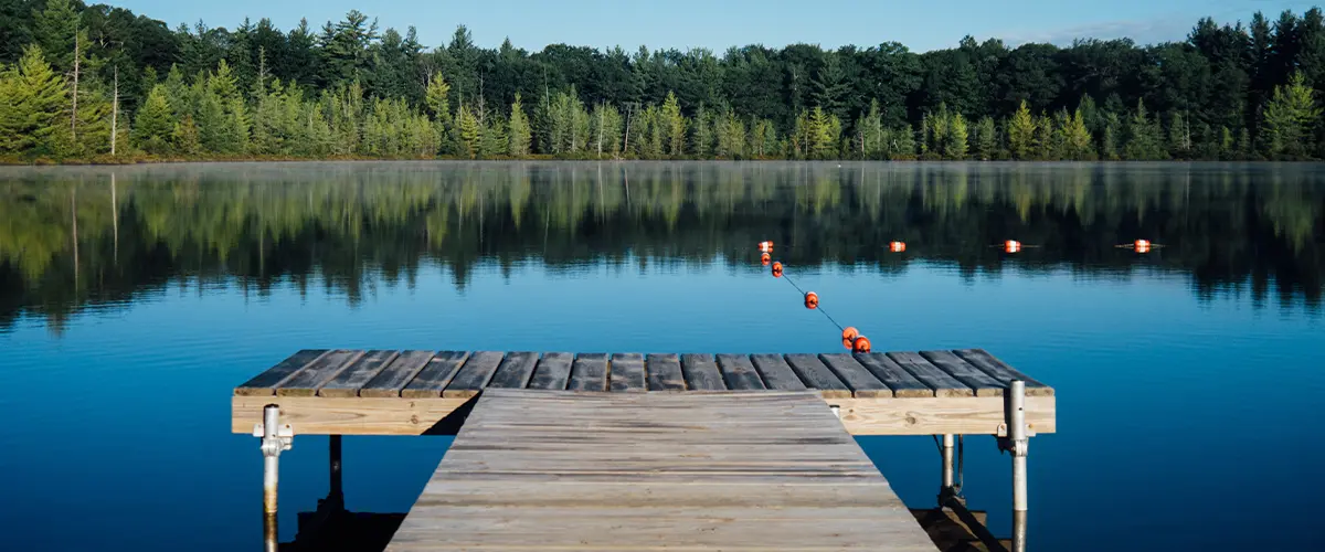 Tranquil Southern Pines dock, reflective lake, lush greenery.