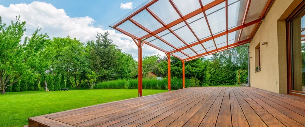 Wooden garden deck with a polycarbonate pergola roof