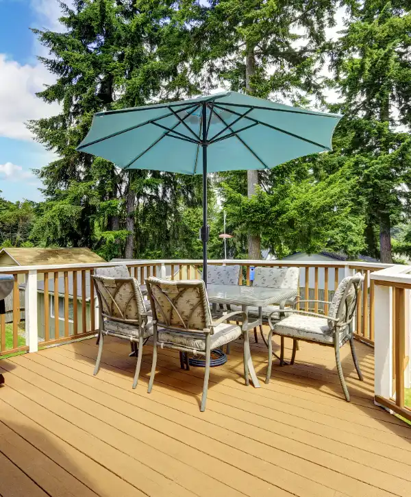 an outdoor deck area furnished with a patio dining set and an umbrella