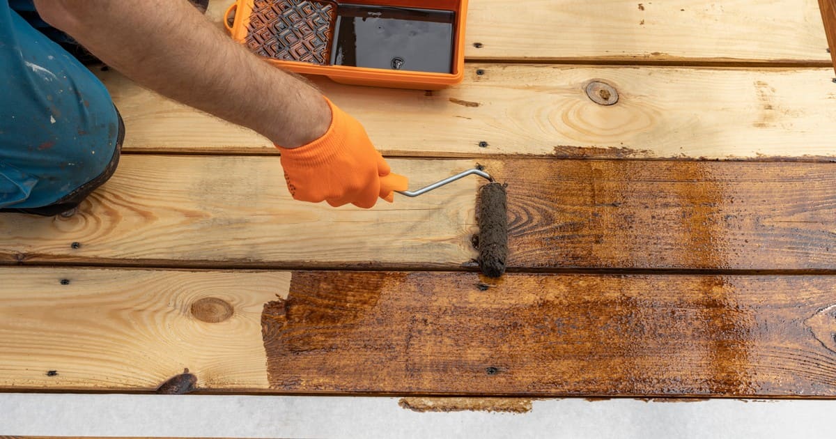 Side by side comparison of wood deck boards with transparent and semi-transparent stain finishes.